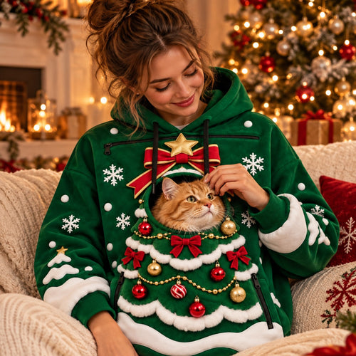Woman wearing the Christmas Tree pet pouch hoodie with a ginger cat